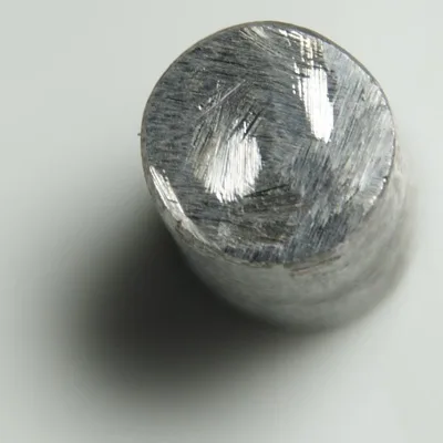 A cylinder of pure iron, distinct in composition from familiar steel products.