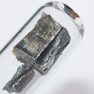 Neodymium. Appearance depends on surface and storage conditions.