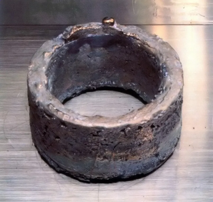 Plutonium sample. Appearance can vary with surface and storage conditions.