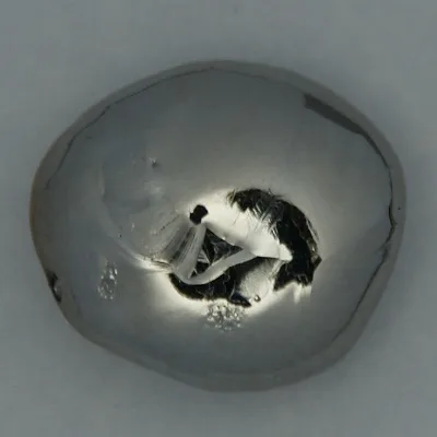 Rhenium. Appearance depends on surface and storage conditions.