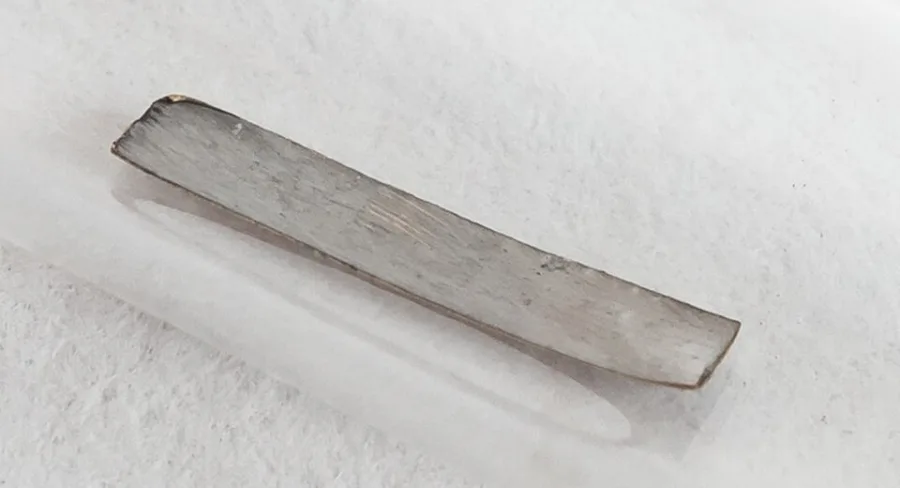 Technetium-99 deposited on foil, inside a sealed ampoule.